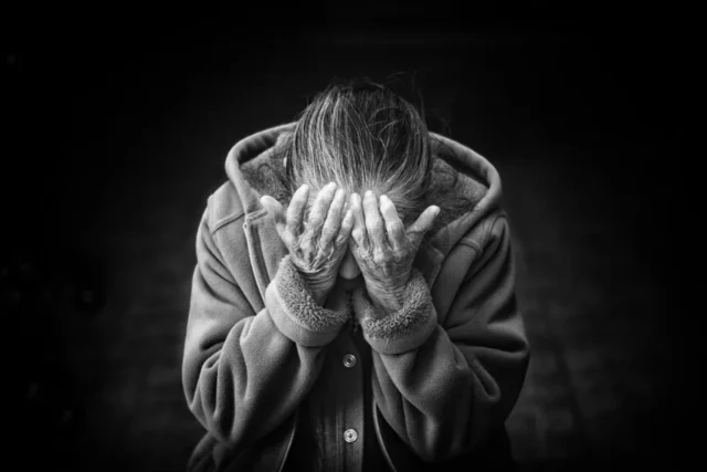 Frustrated person holding their head after forgetting a PIN