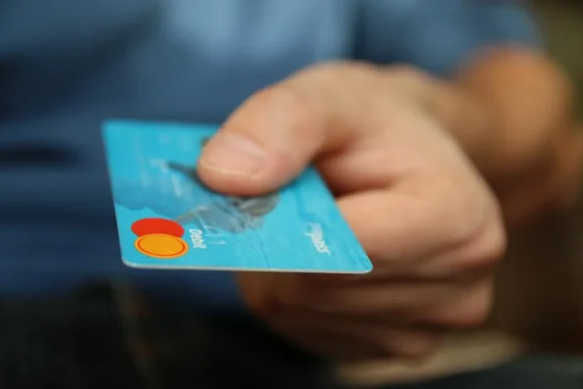 Hand holding a payment card for an app subscription
