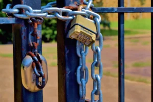 Padlock and chain securing a gate, representing app security