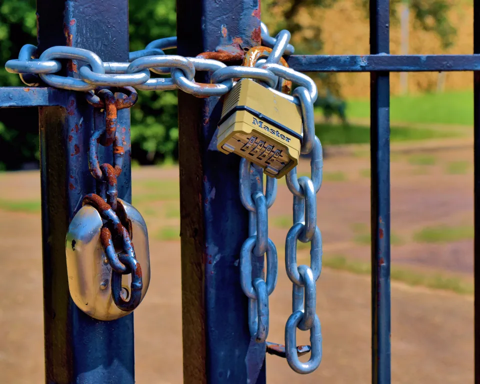 Padlock and chain securing a gate, representing app security