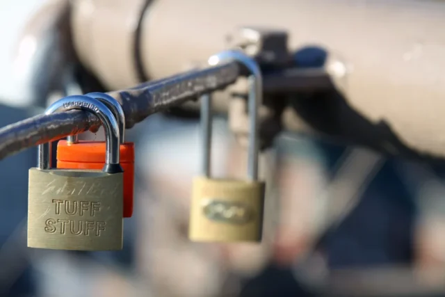 Hand holding a smartphone with a lock screen displayed
