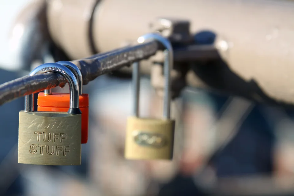 Hand holding a smartphone with a lock screen displayed